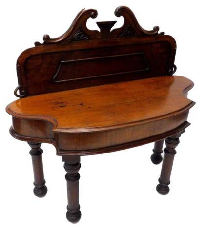 A Victorian mahogany hall table, the raised back with swan neck pediment, with panelled central section, the shaped base with a moulded edge, on turned legs, 113cm W.