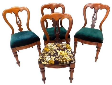 A set of four Victorian mahogany balloon back chairs, each with a padded seat, on turned tapering legs.