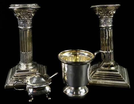 A collection of silver, to include a pair of Corinthian column candlesticks, loaded (AF), a mustard pot with blue glass liner, etc.