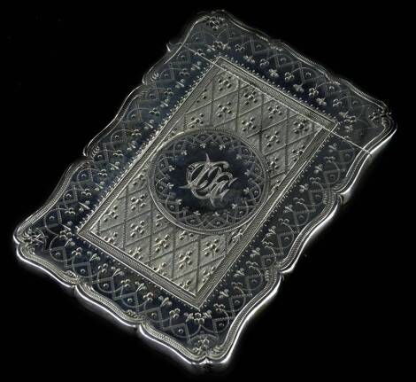 A Victorian silver card case, engraved with scrolls, geometric devices etc., surrounding a circular cartouche with monogram, Birmingham 1868, by Robert Thornton, 2oz.