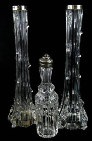 A collection of cut glass items, to include a pair of vases, each with silver collars and a bottle from a cruet with pierced lid.