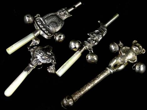 A collection of four silver coloured metal babies rattles, with teethers, to include Mr Punch, two bears and another stamped Baby, marks indistinct.