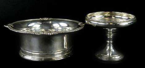 A silver bon bon dish, with a foliate scroll border, on hourglass shaped stem, and loaded base, Birmingham Assay marks, date letter indistinct, 5½oz overall, 9cm H, and a Barker and Ellis silver plated and mahogany waiter. (2)