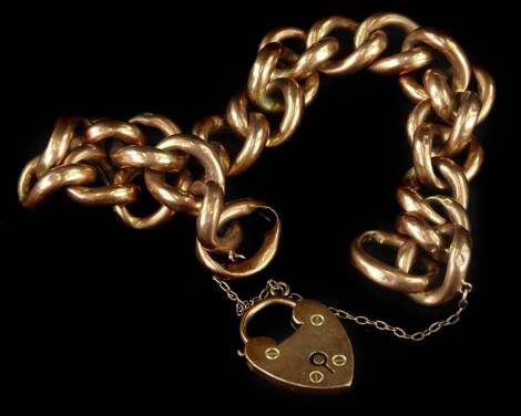 A 9ct gold charm bracelet, with chunky curb links and heart shaped padlock, with safety chain, 23g all in.