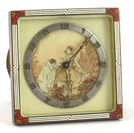 A German Art Deco travelling clock, the dial with a printed decoration of a pierot etc., within a silvered chaptering, the outer case with enamel decoration, 8.5cm H.