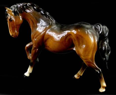 A Beswick brown model of a horse, with one raised leg, 18cm H.