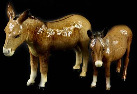 Two Beswick donkeys, the largest 14cm H.