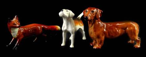 Three Beswick animals, a Daschund, a small fox and a Beagle.