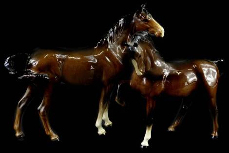 A Beswick model of a brown horse, with one leg raised and another brown horse. (2)