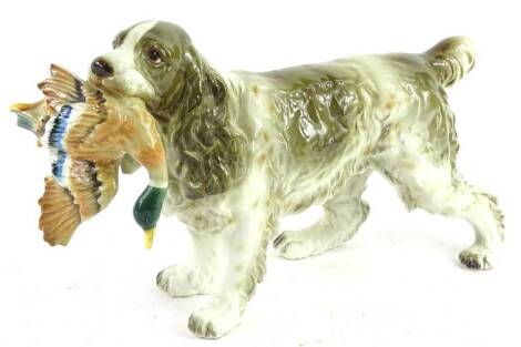 A Beswick style pottery model of a spaniel carrying a duck, 19cm H.