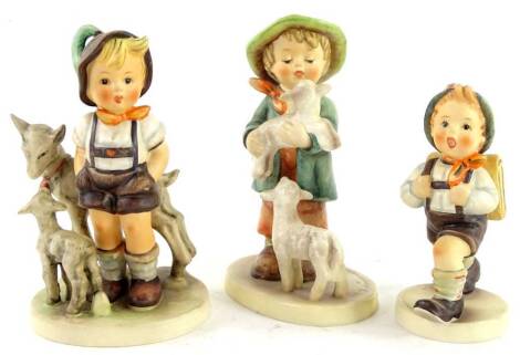 Three Goebel Hummel figures, to include a boy with goat, boy with lambs etc.