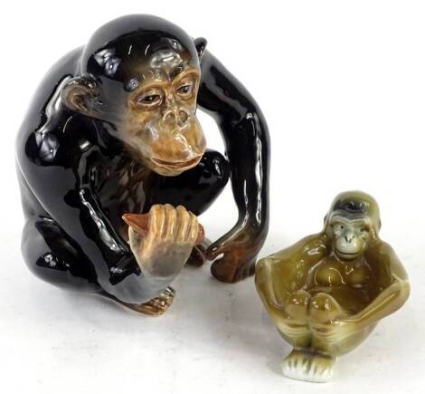 A Sylvac model of a seated chimpanzee, and a Continental porcelain monkey ashtray. (2)