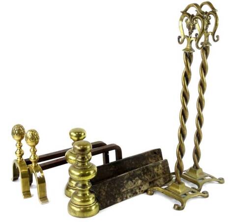 A pair of French fire tool stands or andirons, each with spirally turned column, shaped base, 57cm H. and two pairs of French brass and iron fire dogs or andirons, to include a pair with pineapple type finials, 22cm H.