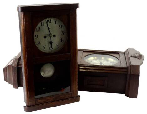 Two 1920's oak wall clocks, each with silvered dials and Arabic numerals, 70cm and 49cm H respectively.