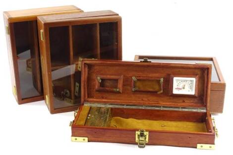 Three Lapaz mahogany cigar cases, 32cm W and a mahogany and brass humidor.