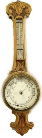 A late Victorian aneroid wheel barometer, in carved oak case (AF), 86cm H.