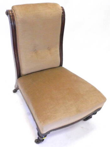 A Victorian walnut nursing chair, with a button back padded seat, on turned tapering legs, with ceramic castors.