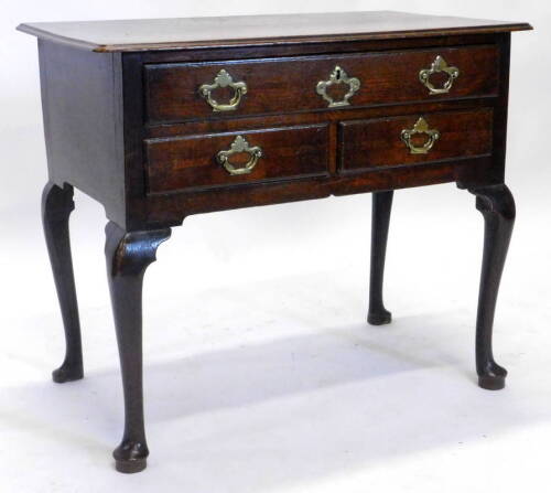 An 18thC oak lowboy, the rectangular top with a moulded edge, above an arrangement of one long and two short drawers, on cabriole legs, with pad feet, 84cm W.