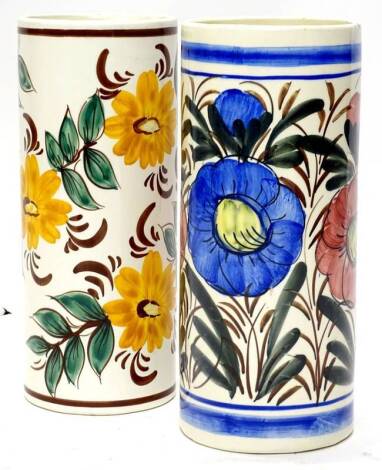 A pair of Continental pottery umbrella stands, each decorated in bright colours with flowers, unmarked, possibly Portuguese, 48cm H.