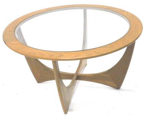 A G-plan retro style circular coffee table, with a smoked glass insert, 84cm dia.