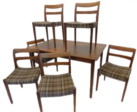 A Swedish retro style teak extending dining table, on turned tapering legs, and a set of six Trodes chairs, designed by Nils Jonsson. The upholstery in this lot does not comply with the 1988 (Fire & Fire Furnishing) Regulations, unless sold to a known exp