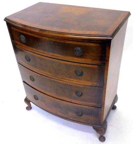 A walnut bow front chest of drawers in George III style, the top with a cross banded border and a moulded edge, above four graduated drawers with circular handles, on cabriole legs, 90cm H, 46cm D, 75cm W.