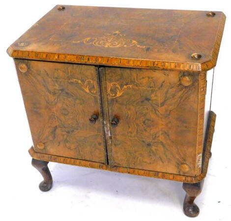 A Victorian walnut low cupboard, with parquetry borders and marquetry inlaid top and doors, on later cabriole legs, 54cm W.