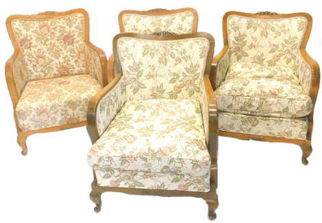 A set of four early 20thC beech continental show frame armchairs, each with floral fabric on cabriole legs.