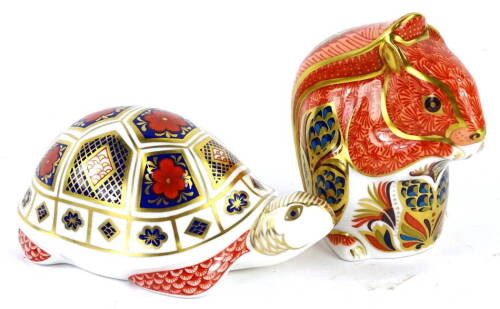 Two Royal Crown Derby paperweights, comprising a squirrel with silver stopper and a turtle with silver stopper, red marks to underside LXI, boxed.