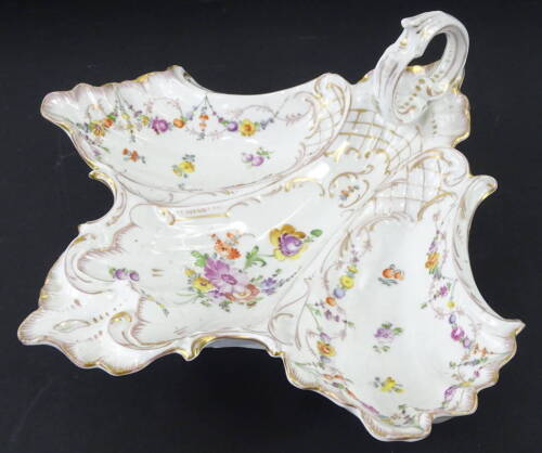 An early 20thC P. Donath Silesian German porcelain dish, the three sectional centre with gilt highlight and hand painted flowers, with a scroll handle on shaped foot, blue crown and S mark beneath, 30cm W.