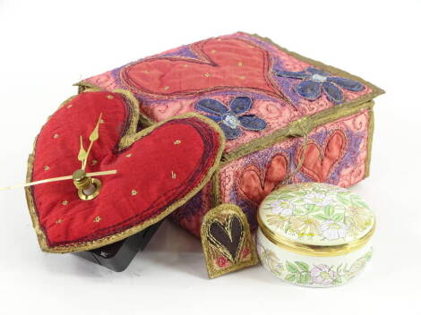 A Claire Sowden small fabric heart shaped clock, in a similarly embroidered travelling box with heart motifs and an enamel box.