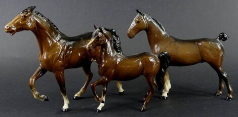 Three Beswick brown horses, to include two with raised legs, various sizes.