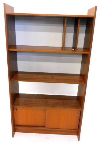 A 1970's/80's retro style teak bookcase or record cabinet, with various shelves and two sliding doors, each with metal handles, 90cm W.