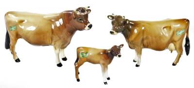 A 20thC Beswick Jersey bull, cow and calf group, Ch Dunsley Coy Boy 12cm H, Newton Tinkle and calf, printed marks beneath. (3)