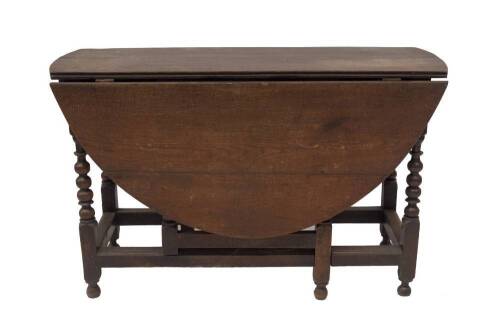 A 17thC oak gateleg table, with oval dropleaf top, frieze drawer, bobbin turned legs and moulded square stretchers and turned feet, 122cm L, 138cm maximum W.