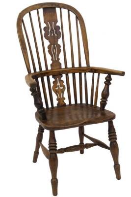 An early 19thC ash and elm high back Windsor chair, with Christmas tree splat, turned supports, burr seat and triple ringed turned forelegs, and H frame stretcher, 62cm W.