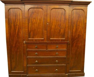 A Victorian mahogany breakfront wardrobe compactum, with moulded cornice, full length panelled doors flanking a centre of two similar arch panelled doors, revealing press drawers over two short and two long graduated drawers with pressed glass knob handl - 2