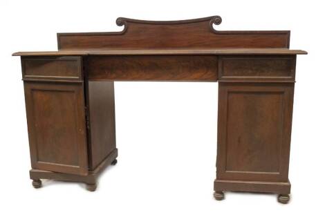 A William IV mahogany inverted breakfront sideboard, with moulded top, flame veneer central frieze drawer, flanked by two panel doors having a cellarette to the left and open base to the right, each with sliding drawers, plinth base with turned feet, 96cm