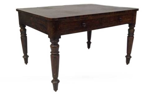 A George IV rosewood writing or library table, with leather skiver top, cross banded with a veneer border, having two frieze drawers to each side with knob handles on taper turned legs, all with simulated grain painting, 74cm H, 122cm W, 92cm D.