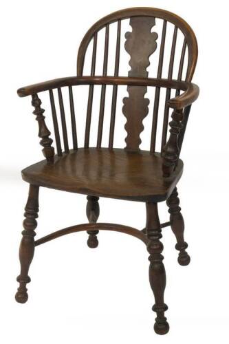 An early 19thC yew wood low back Windsor chair, with solid splat back, turned supports, triple ring turned legs and feet, with crinoline stretcher, 54cm W.