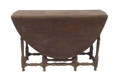 A 17thC walnut gateleg table, with oval drop leaf top, single frieze drawer, baluster turned legs and stretchers, on turned feet, 112cm L.