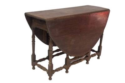 A 17thC walnut gateleg table, with oval drop leaf top, single frieze drawer, baluster turned legs and stretchers, on turned feet, 112cm L. - 2