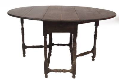 A 17thC walnut gateleg table, with oval drop leaf top, single frieze drawer, baluster turned legs and stretchers, on turned feet, 112cm L. - 3