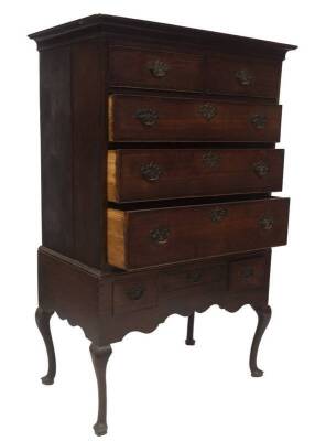 A George III oak chest on stand, with moulded cornice, over two short and three long graduated cock beaded drawers with mahogany cross banding, pierced brass back plate handles and matching escutcheons, the lower part having an arrangement of three drawer - 3