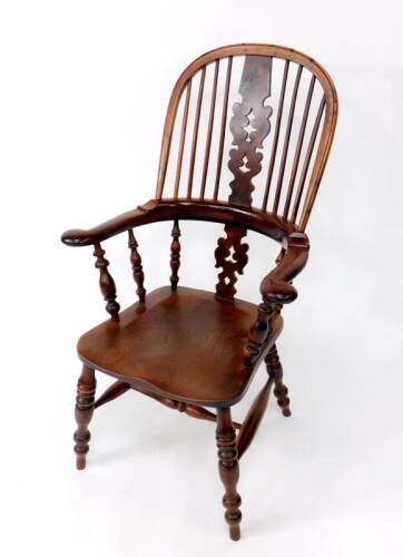 An early 19thC yew wood high back Windsor chair, with Christmas tree splat, bow arms, turned supports, ring turned legs and H frame stretcher, 66cm over arms.