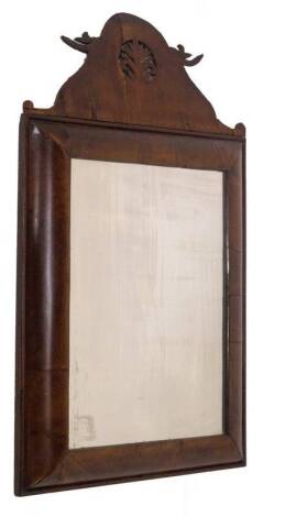 A George II walnut wall mirror, with fret work pediment, cushion moulded frame and rectangular plate, 66cm x 37cm.