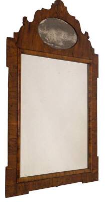 A George II olivewood veneered wall mirror, with fret work pediment, having an oval engraved mirror glass panel with a female figure and floral garland surround, rectangular plate, 90cm x 57cm.