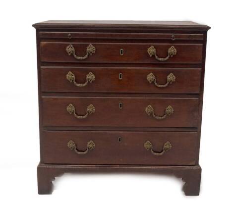 A George III mahogany bachelor's chest, with crossbanded top, flame veneered brushing slide, over four graduated moulded oak lined drawers, with brass swan neck handles and rococo pierced back plates, on bracket feet, 82cm H, 79cm W, 45cm D.