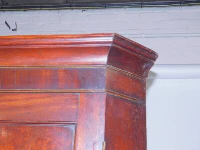 A George III tall standing corner cupboard, with canted sides and plain moulded cornice and frieze, with three serpentine shaped shelves to the upper cabinet and enclosed with panelled doors, having ivory escutcheons, on low bracket feet, 228cm H, 106cm W - 2