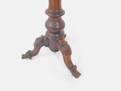 An early Victorian rosewood circular tripod centre table, with specimen marble top within a moulded border and plain deep frieze supported upon a tapered baluster column, with scrolling legs having carved flower heads, scroll feet and brass castors, 74cm - 3